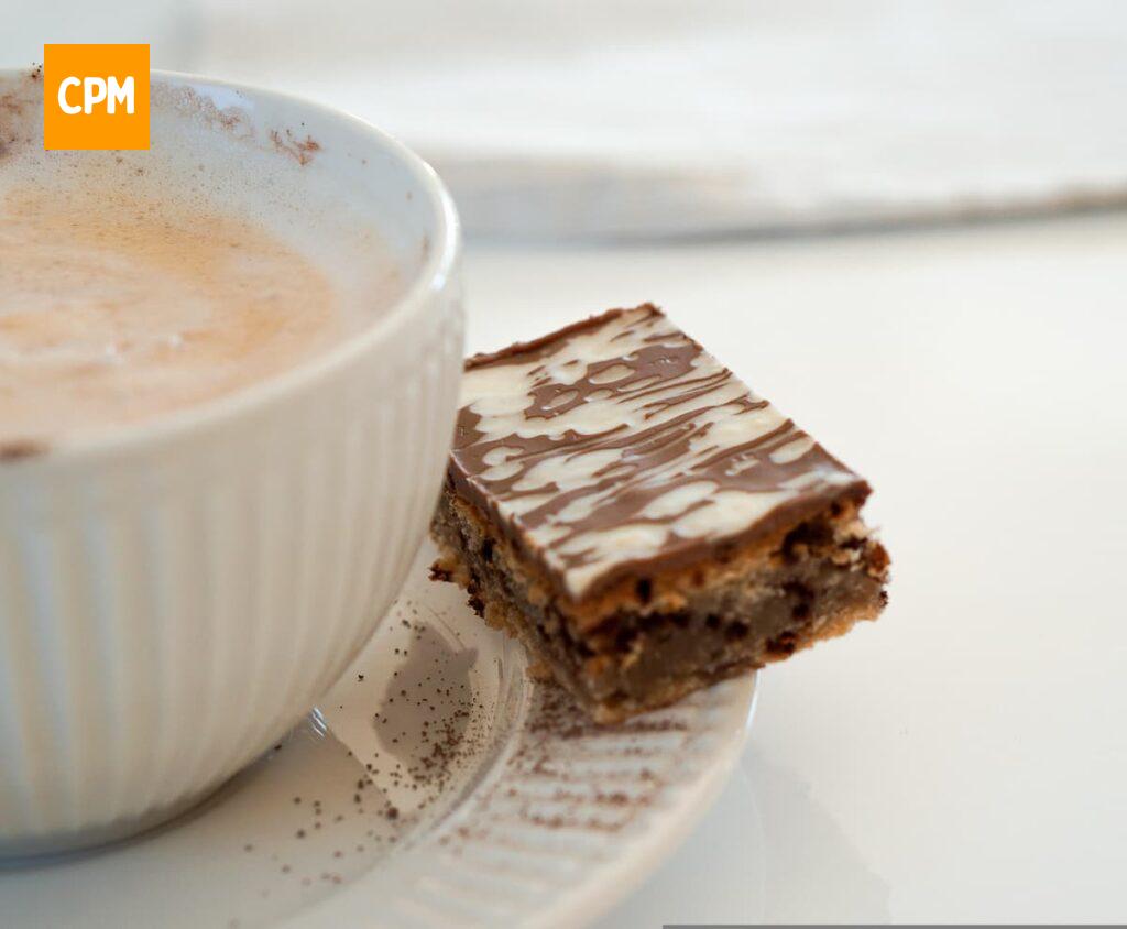 Imagem mostra mini brownie de chocolate servido com Capuccino.